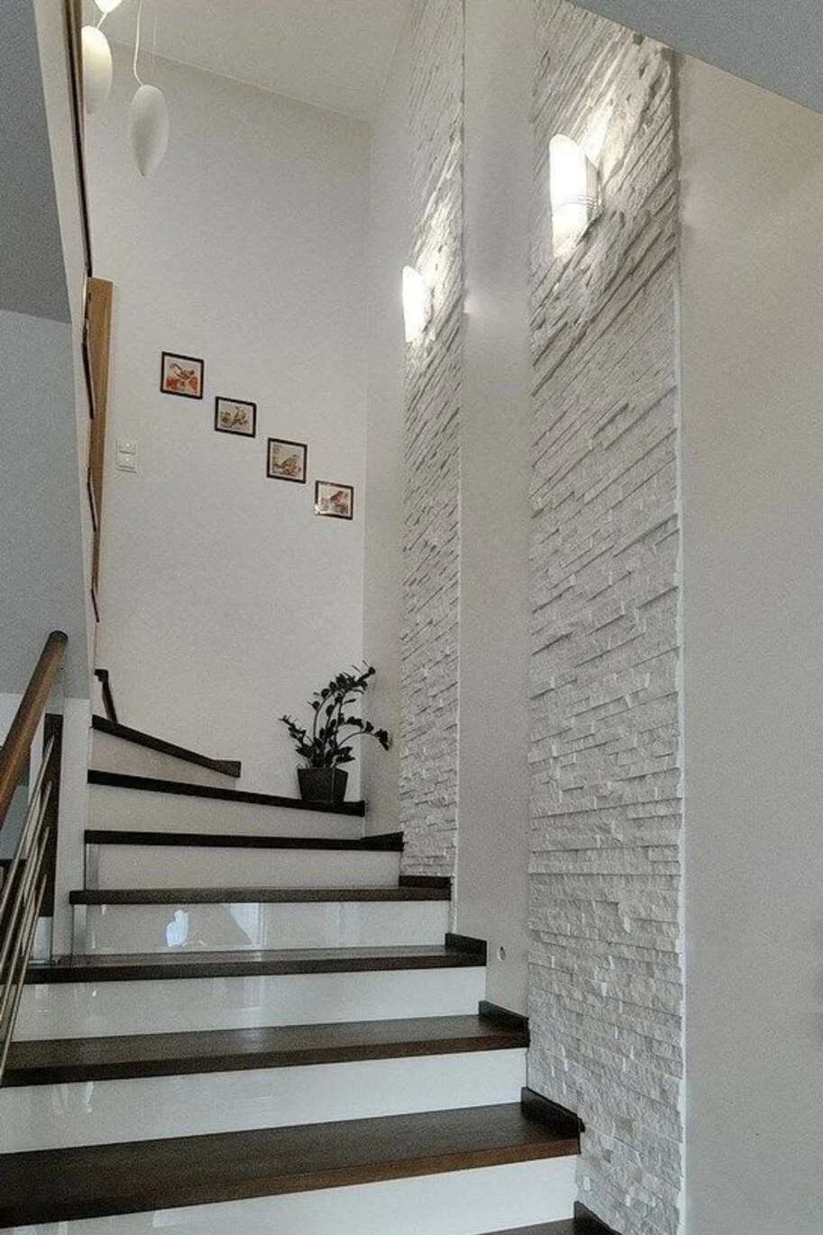 a staircase wall decorated with textured wall finish like stone