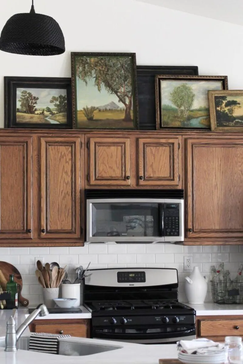 10 Decorating Ideas for Above Kitchen Cabinets to Transform Your Kitchen 4 a kitchen with frame prints above cabinets