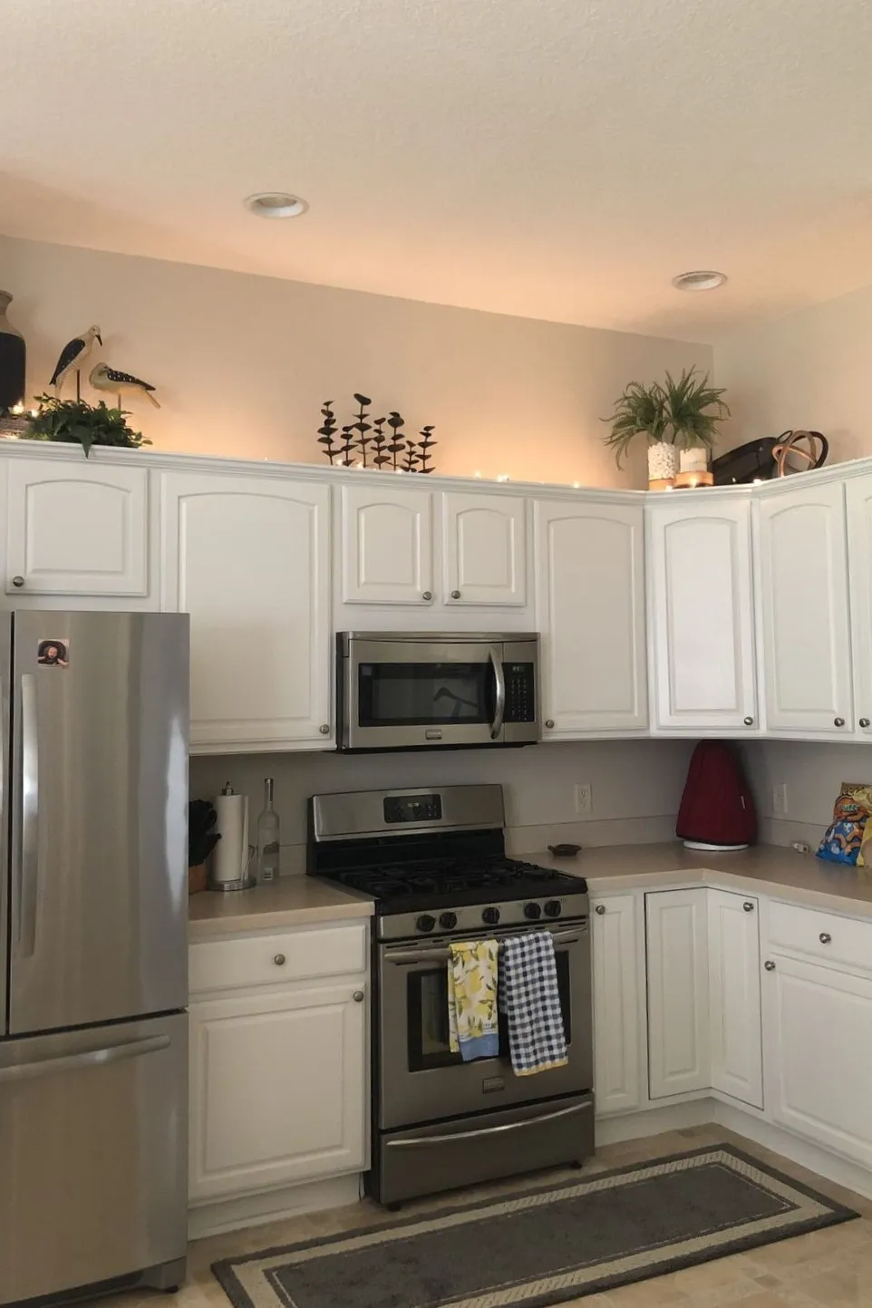 10 Decorating Ideas for Above Kitchen Cabinets to Transform Your Kitchen 9 a kitchen with upward lights above cabinets