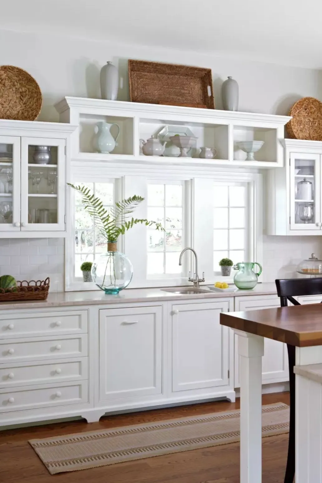 10 Decorating Ideas for Above Kitchen Cabinets to Transform Your Kitchen 6 a kitchen with wooden trays above cabinets