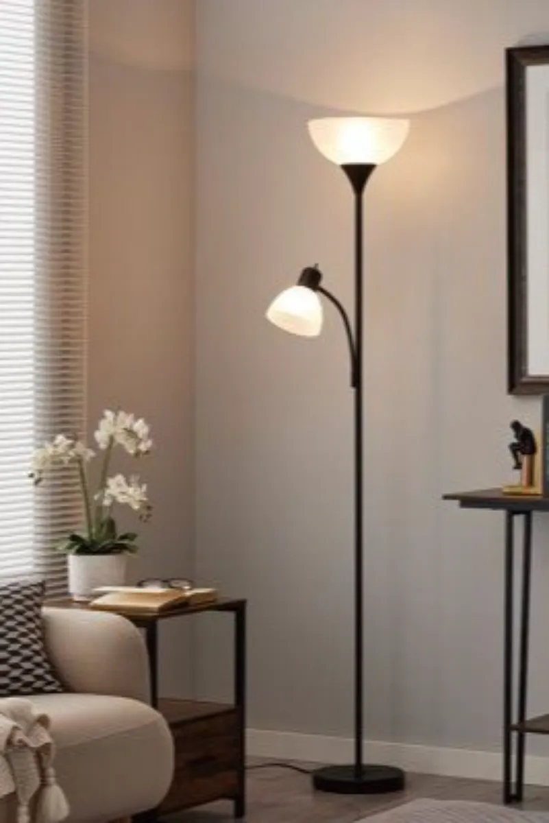 a living room with torchiere floor lamps