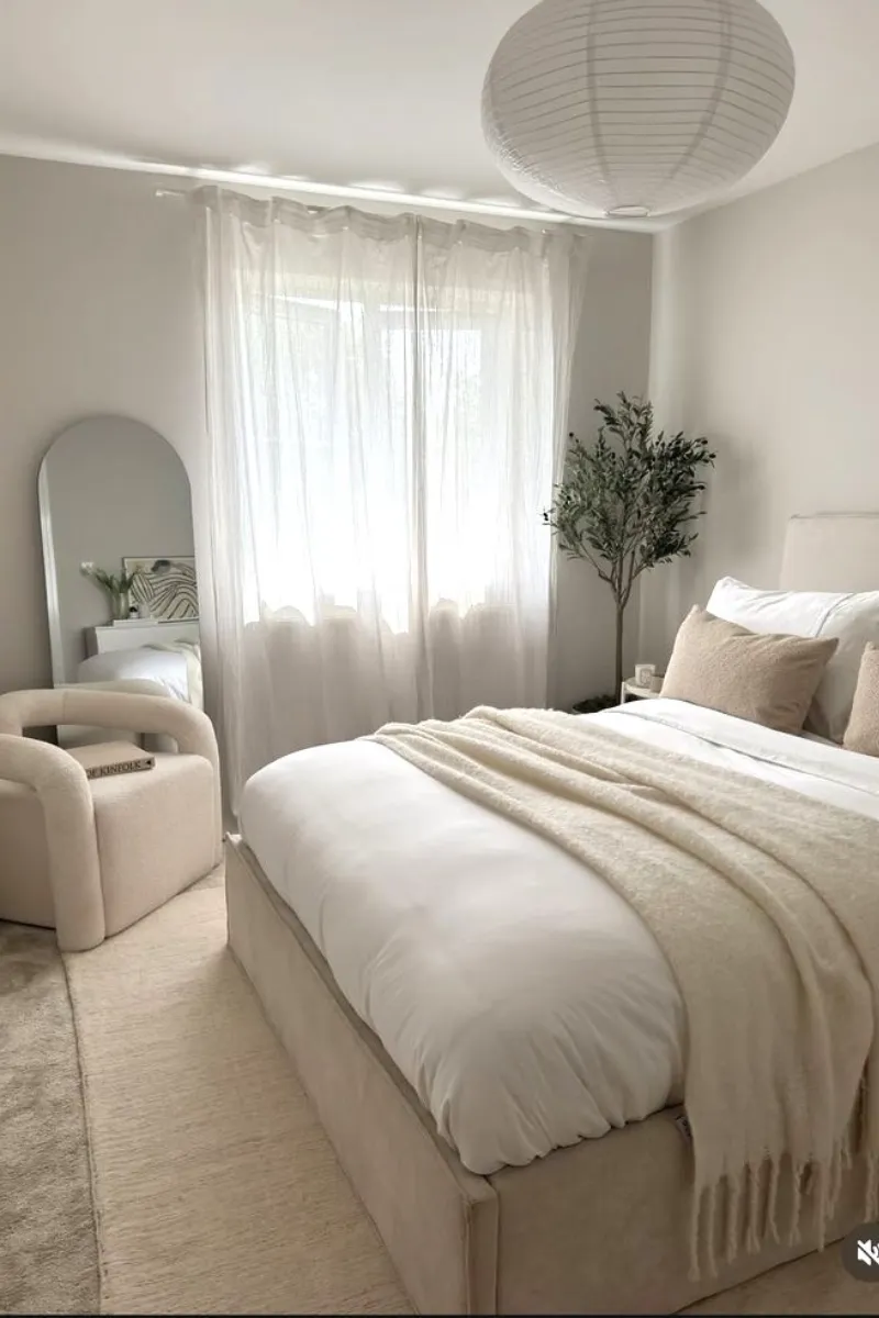 10 Modern White Bedroom Ideas for a Clean and Calm Look 8 a white bedroom with sheer curtain and mirror
