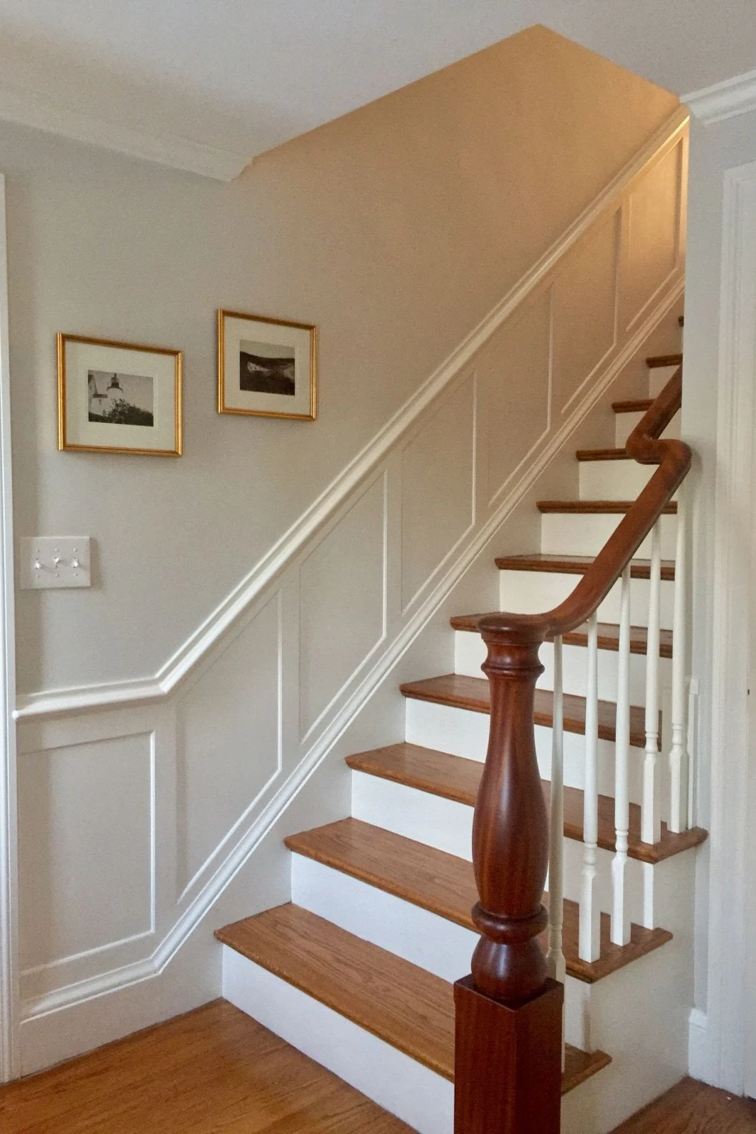 a staircase wall decorated with half wall wainscoting