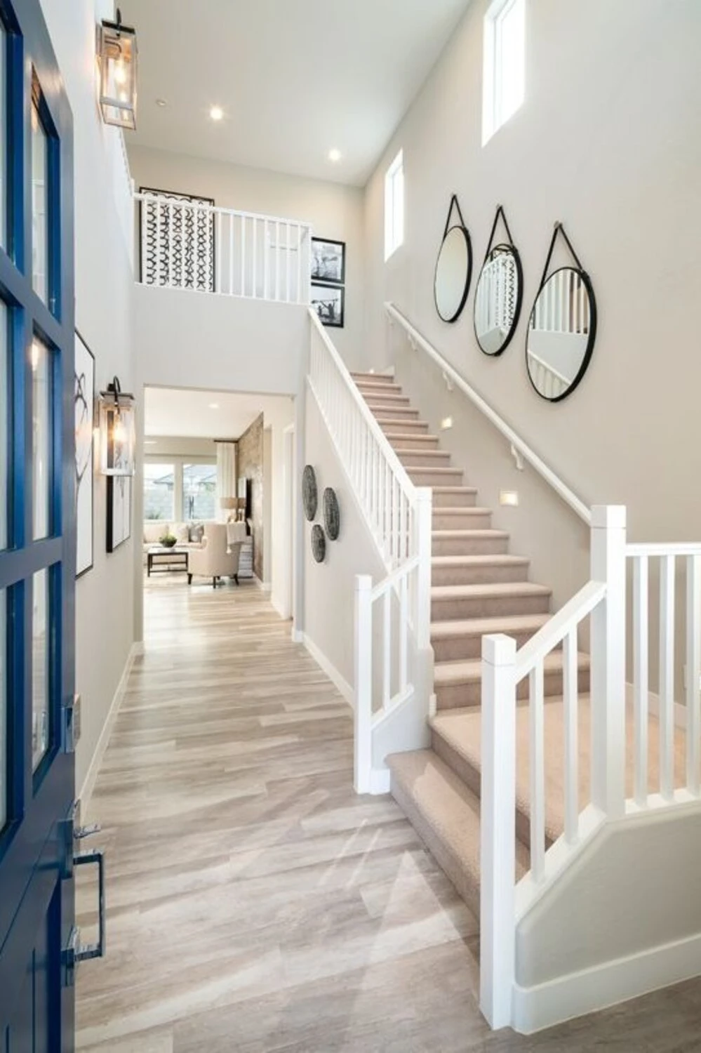 a staircase wall decorated with round mirrrors