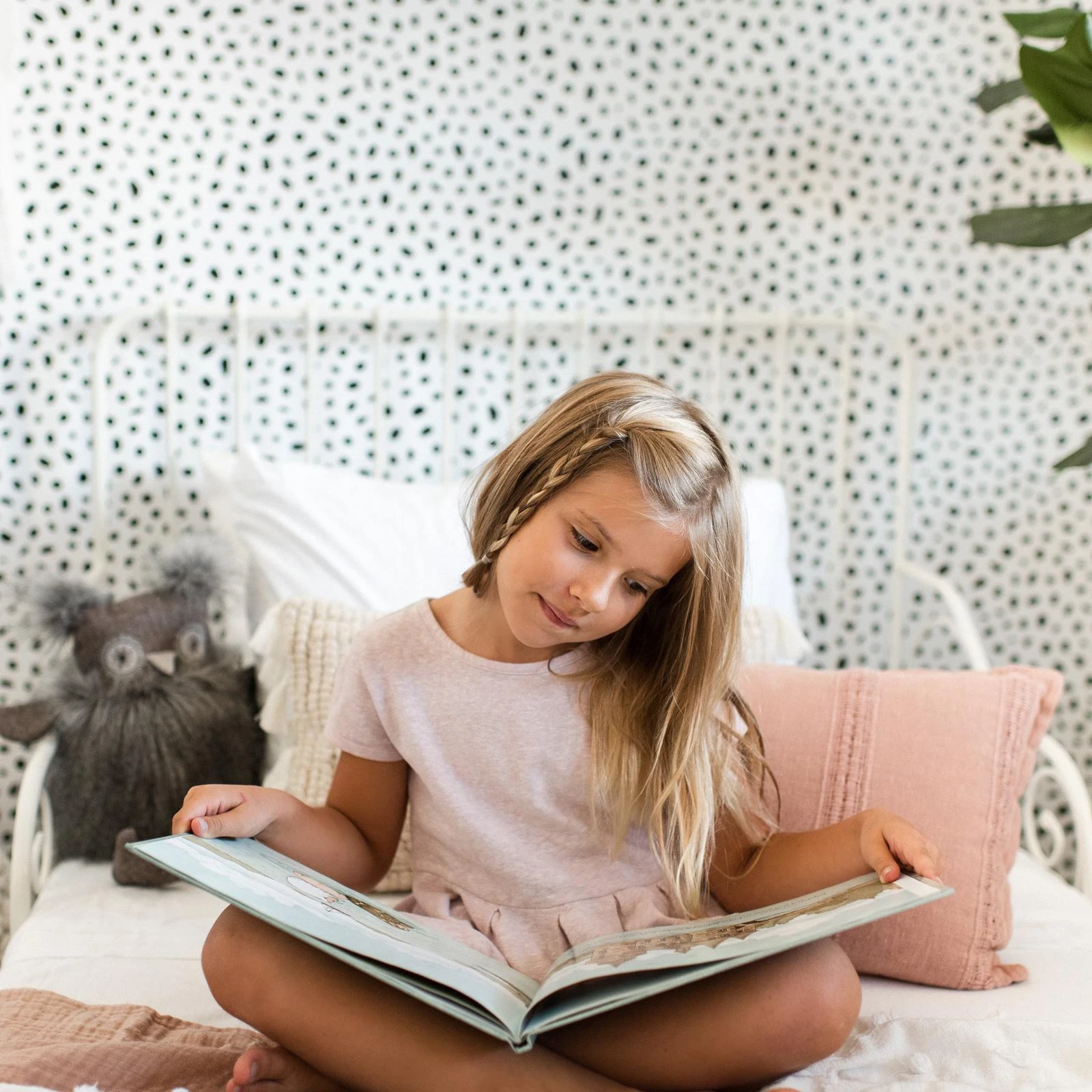 7 Of The Cutest Design Ideas For a Reading Nook For Your Kids 5 a kid reading a book on bed