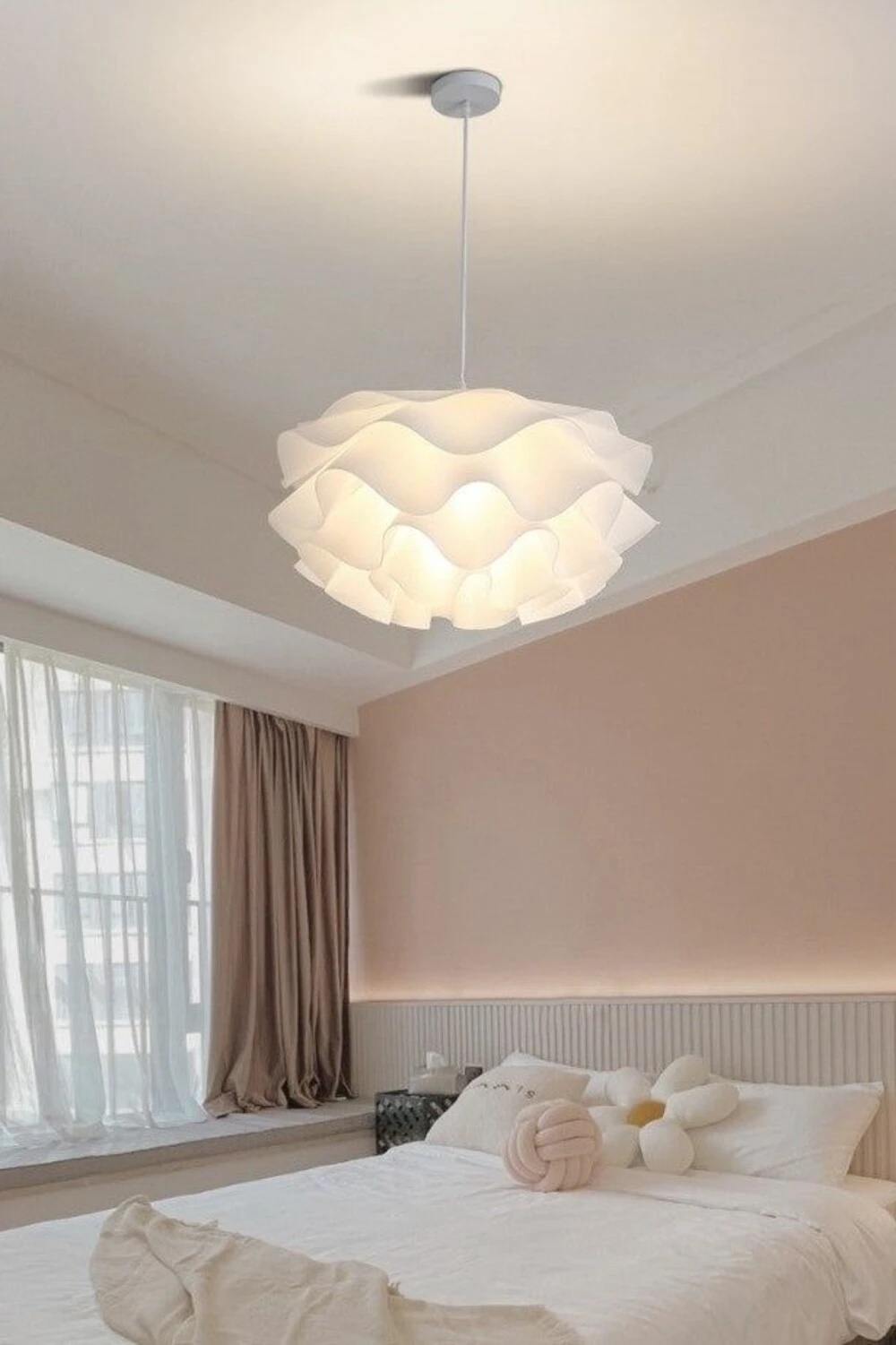 a calm bedroom with oversized fabric pendant ceiling light