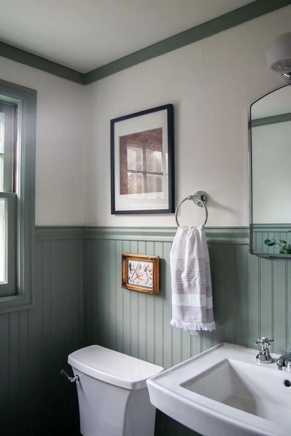 a bathroom with beadboard wainscoting