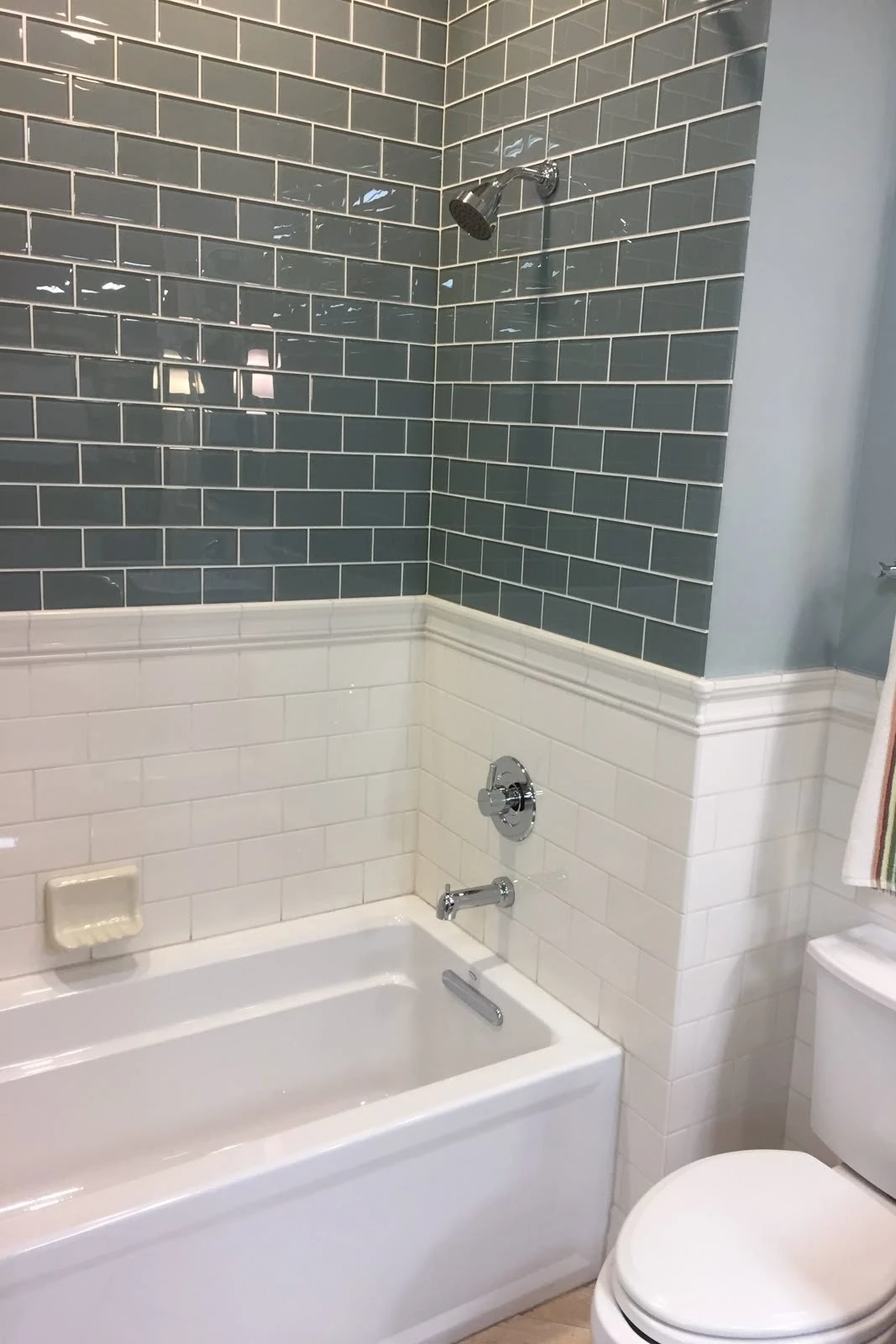 a bathroom with wainscoting tile