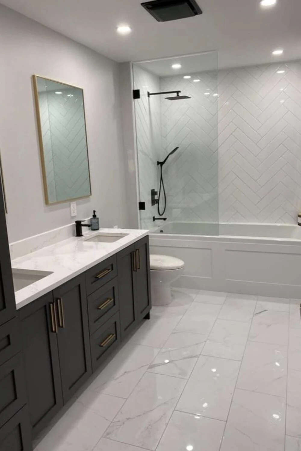 a small bathroom with glossy floor tile