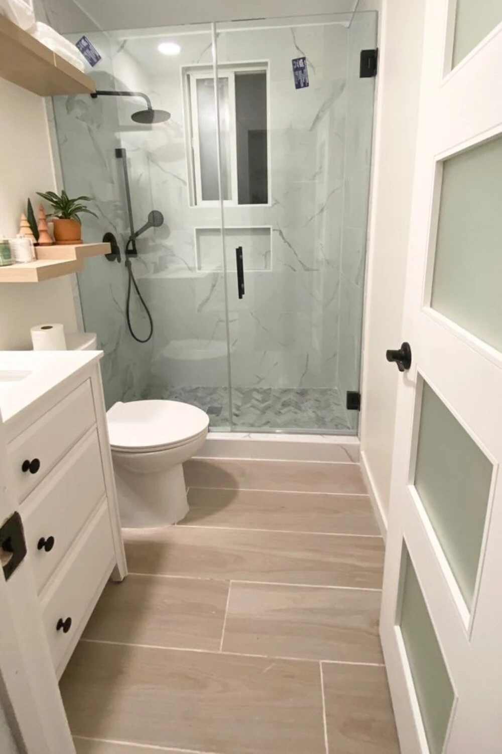 a small bathroom wtih horizontal floor tile