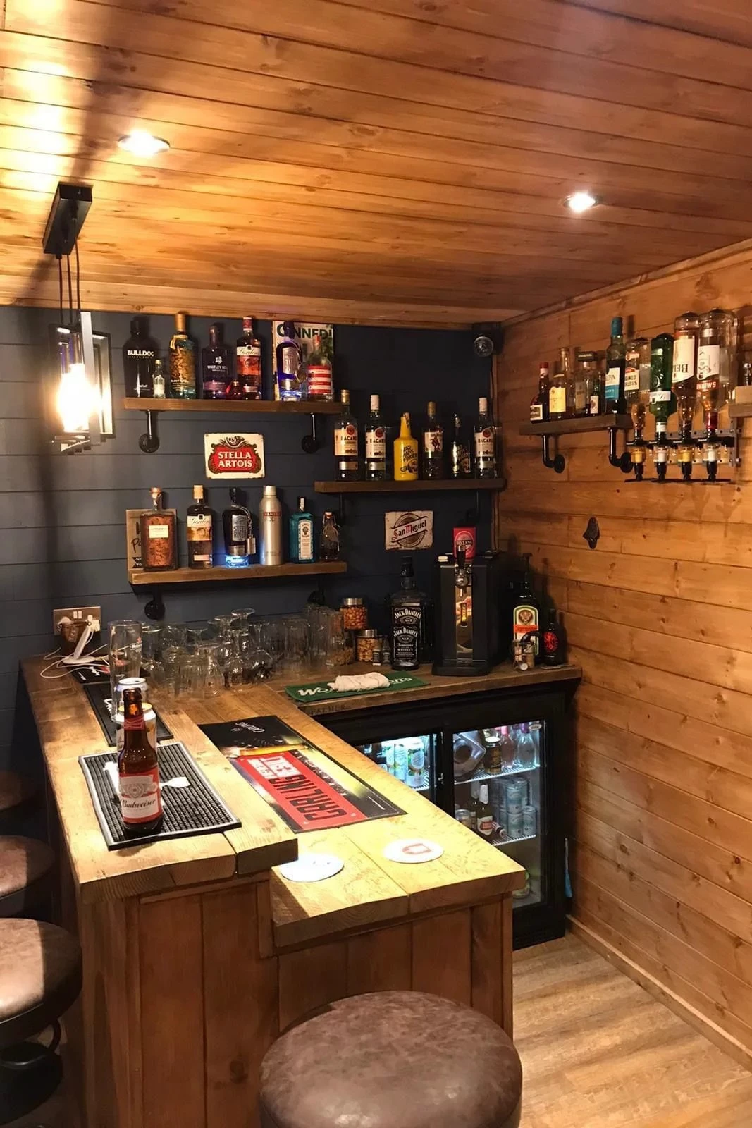 a l-shaped basement bar using kitchen cabinets