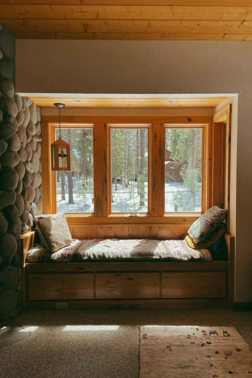 How to Make a Cozy Reading Nook That's Actually Warm All Winter (Not Just Pretty) 3 a reading nook near window with pillow