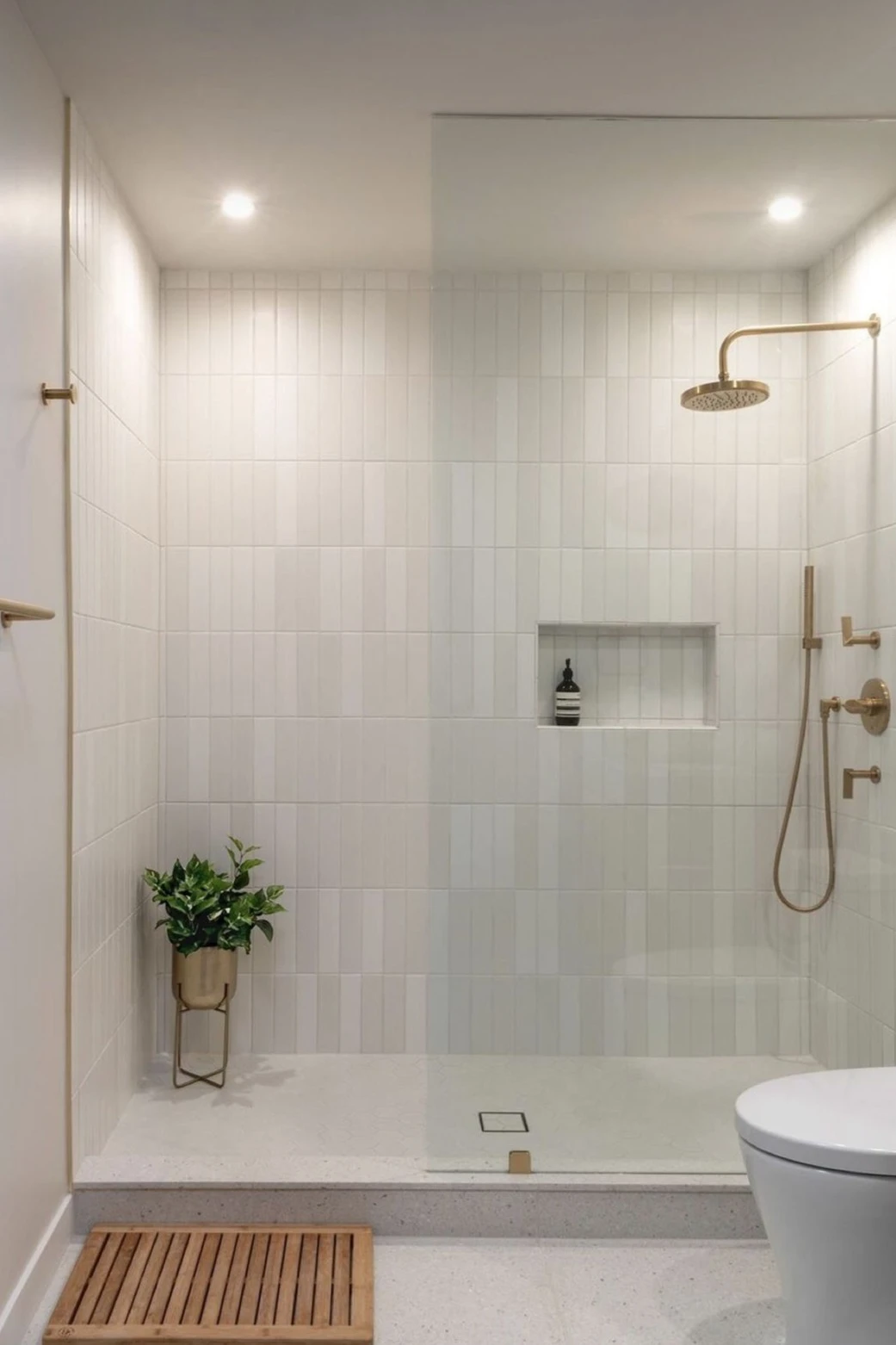 How to Design a Small Bathroom Shower: 12 Space-Saving Ideas 8 a small bathroom with vertical tiles