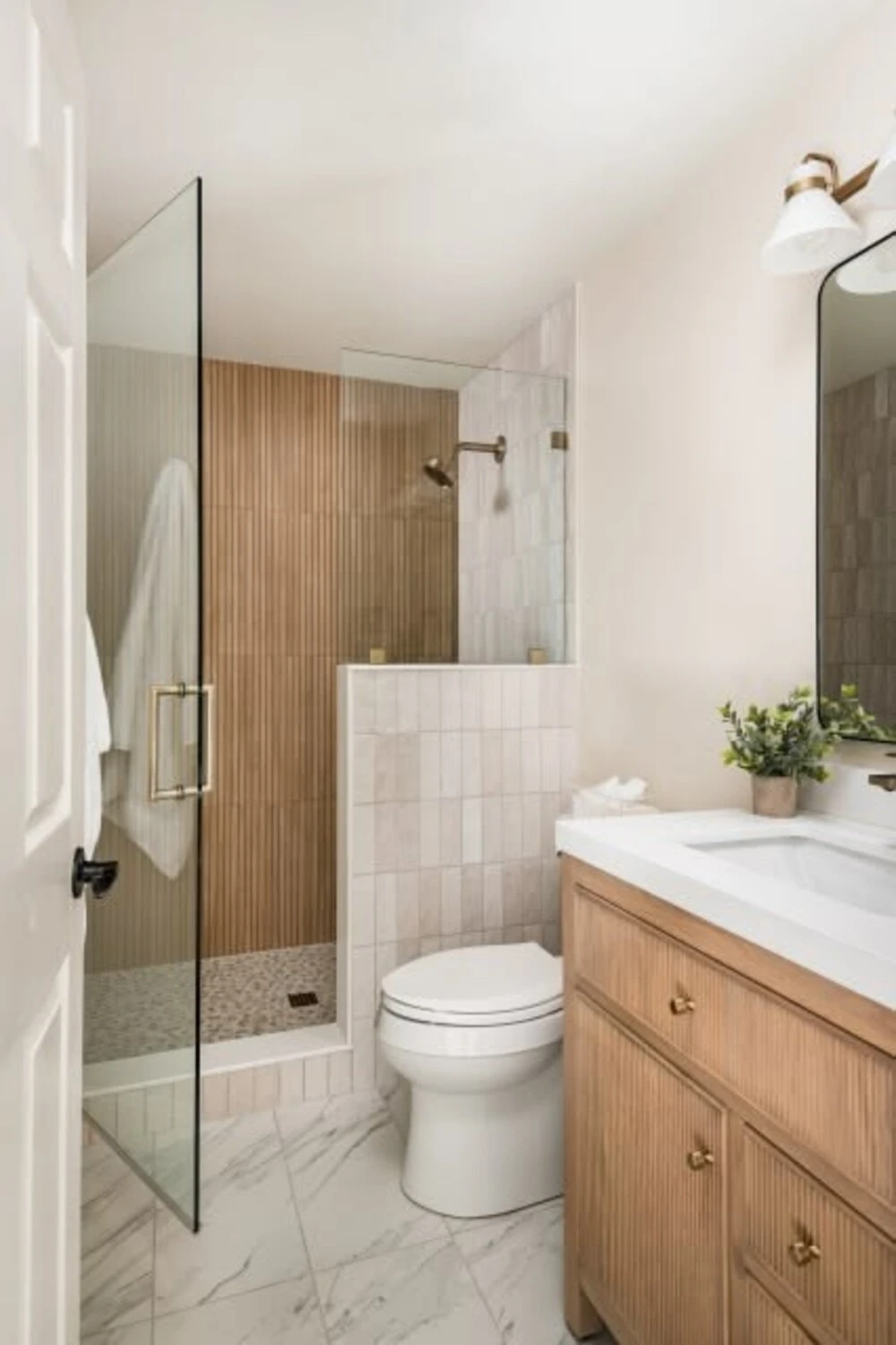 How to Design a Small Bathroom Shower: 12 Space-Saving Ideas 13 a small bathroom with wood tone accent wall