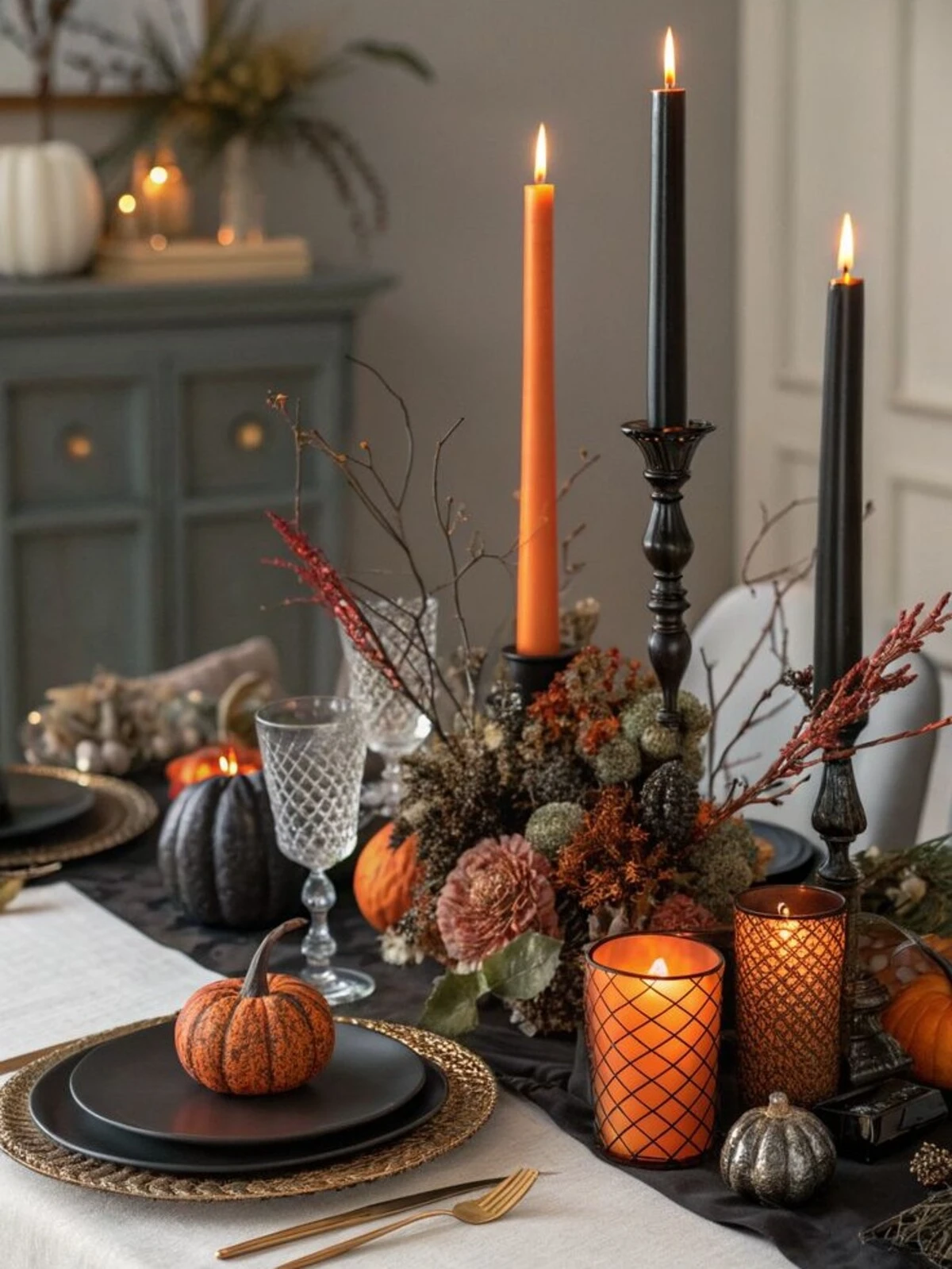 a table with black taper candles